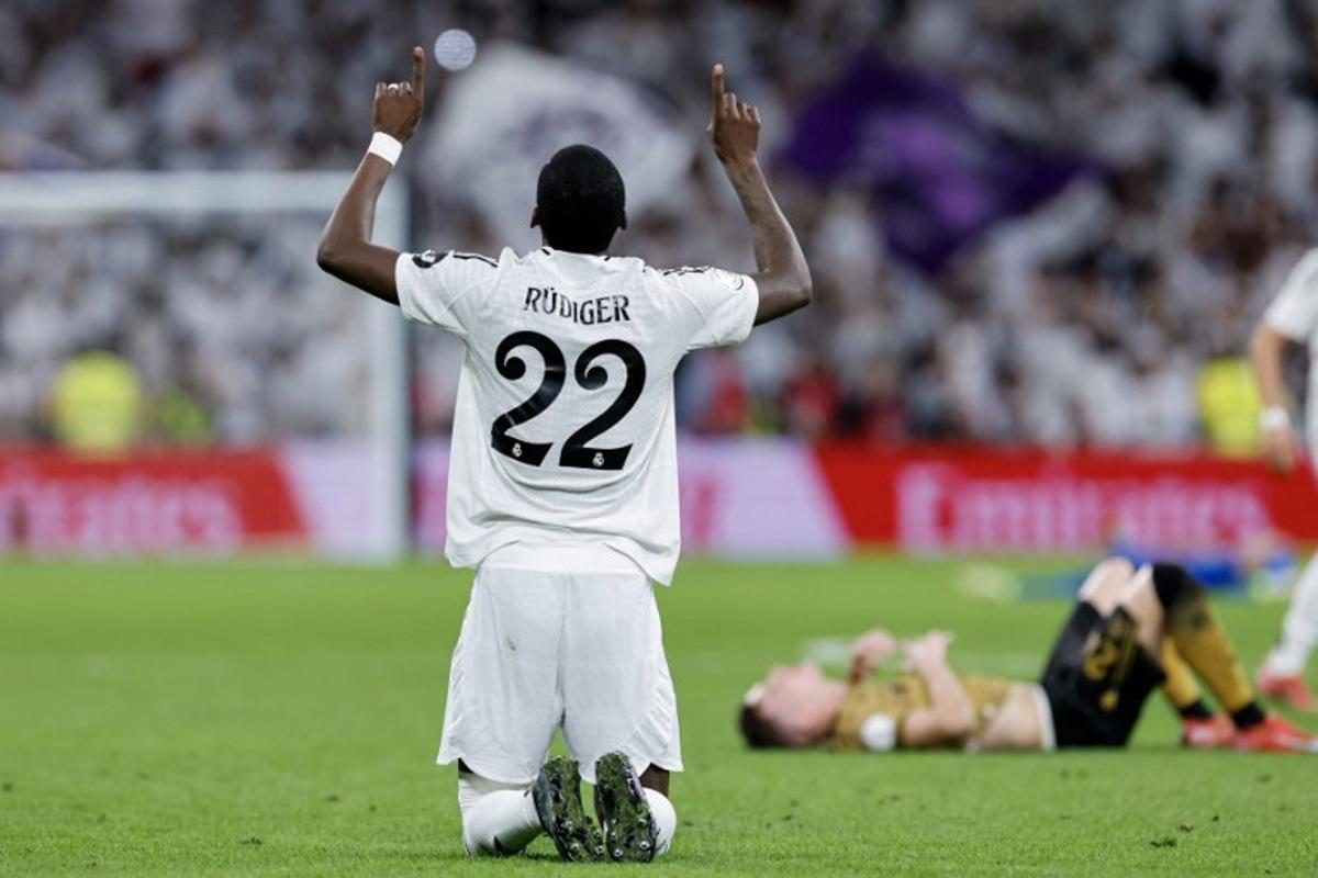 Real Madrid's German defender #22 Antonio Ruediger celebrates at the end of the Spanish Copa del Rey (King's Cup) semi-final second leg football match between Real Madrid CF and Real Sociedad at the Santiago Bernabeu stadium in Madrid on April 1, 2025. OSCAR DEL POZO / AFP