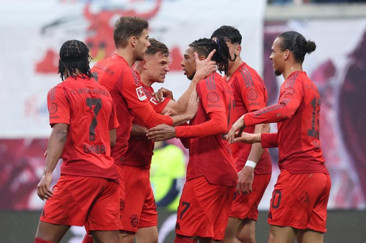 Bayern Munich's French midfielder #17 Michael Olise celebrates with teammates the 2-2 during the German first division Bundesliga football match between RB Leipzig and FC Bayern Munich in Leipzig, eastern Germany on May 3, 2025. RONNY HARTMANN / AFP