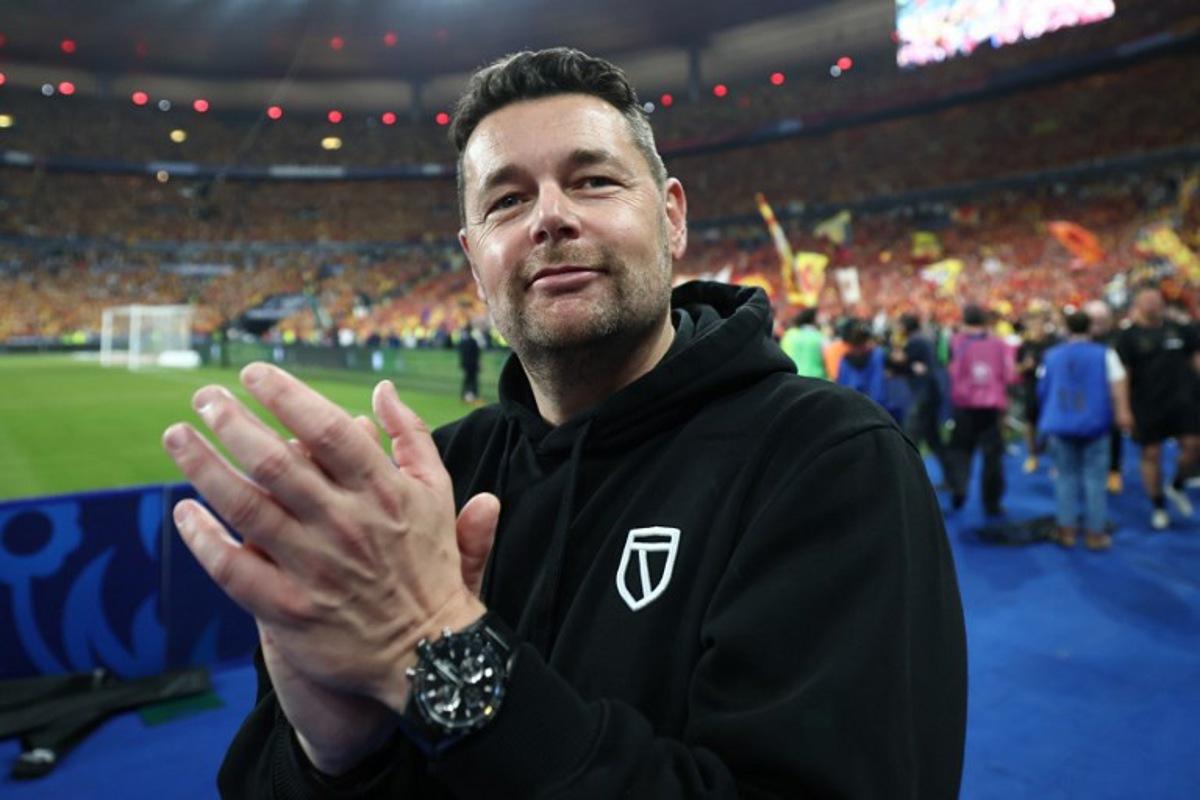 Lens' French head coach Pierre Sage celebrates winning at the end of the French Cup final football match between RC Lens and OGC Nice at the Stade de France stadium, in Saint-Denis, on the outskirts of Paris, on May 22, 2026. FRANCK FIFE / AFP