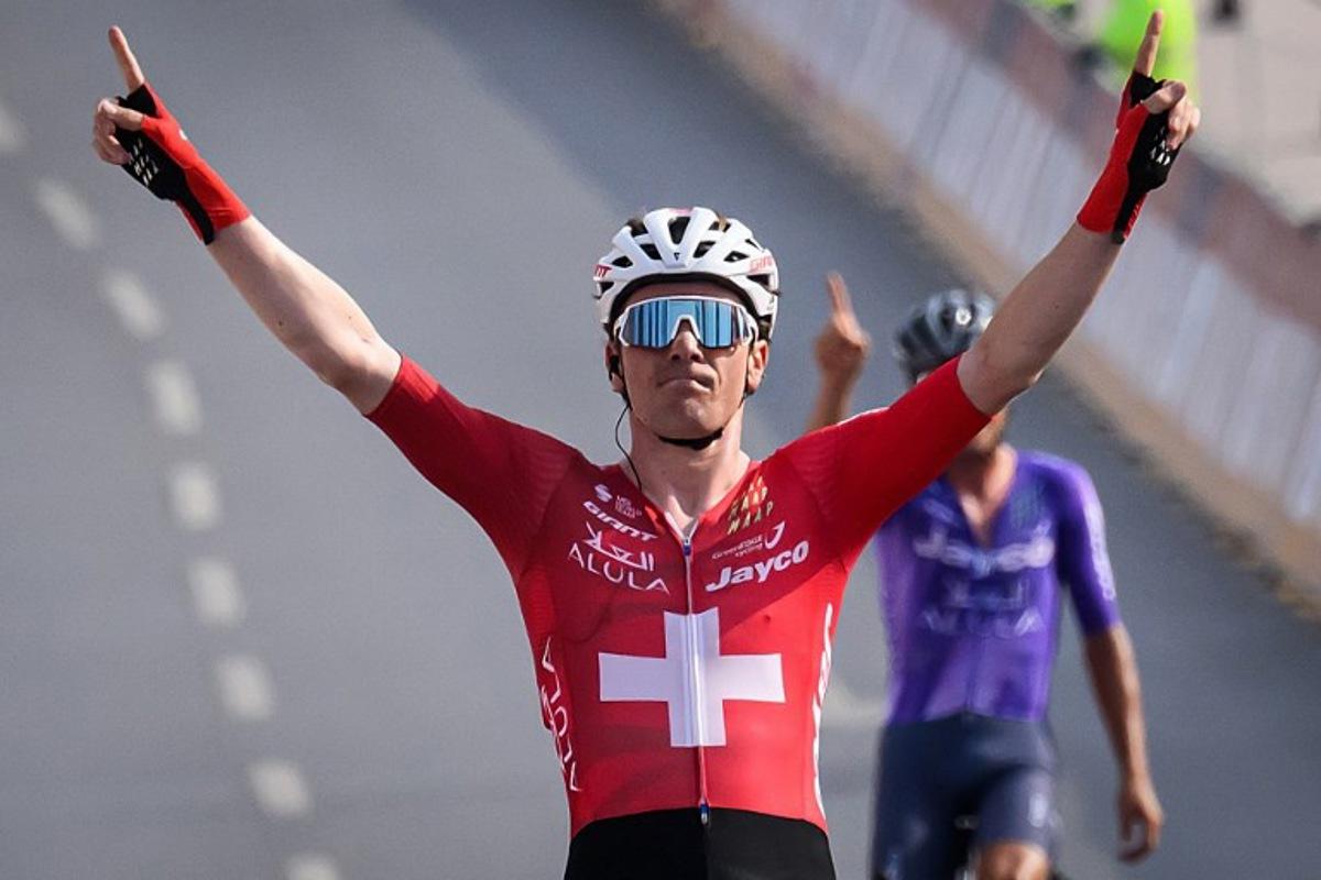 Team Jayco AlUla Swiss rider Mauro Schmid celebrates as he crosses the finish line to win the Muscat Classic cycling race in Muscat, on February 6, 2026. Loic VENANCE / AFP