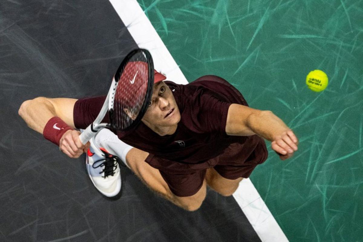 Italy's Jannik Sinner serves to Canada's Felix Auger-Aliassime during their men's singles final match on day seven of the Paris ATP Masters 1000 tennis tournament at the Paris La Défense Arena in Nanterre, on the outskirts of Paris, on November 2, 2025. Dimitar DILKOFF / AFP