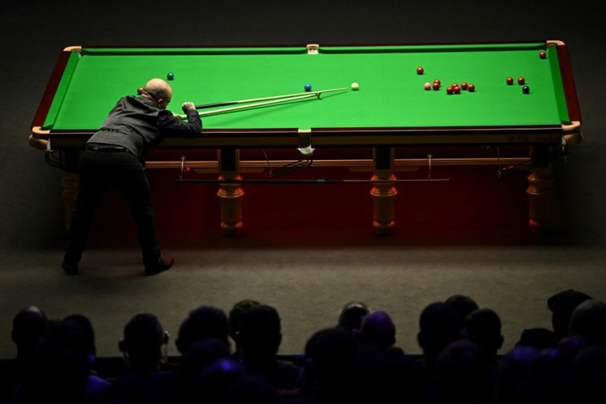Belgium's Luca Brecel plays a shot against England's Mark Selby during the evening session on day two of their World Championship Snooker final match at The Crucible in Sheffield, northern England on May 1, 2023. Oli SCARFF / AFP