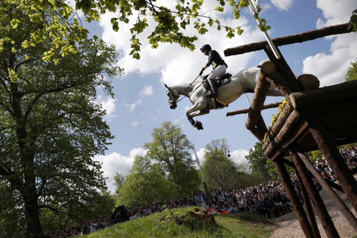 Germany's Christoph Wahler riding Carjatan S jumps the Ford Broken Bridge fence during the cross-country test of the Badminton Horse Trials in Badminton, central England on May 7, 2022. ADRIAN DENNIS / AFP