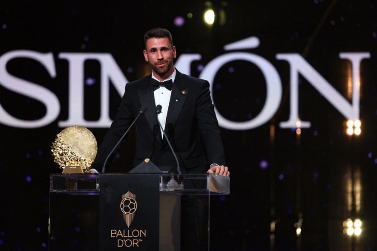 Spain's goalkeeper Unai Simon speaks after receiving the Yashin Trophy for the best male goalkeeper during the 2026 Ballon d'Or France Football award ceremony at the Palladium Theatre in London on October 26, 2026. FRANCK FIFE / AFP