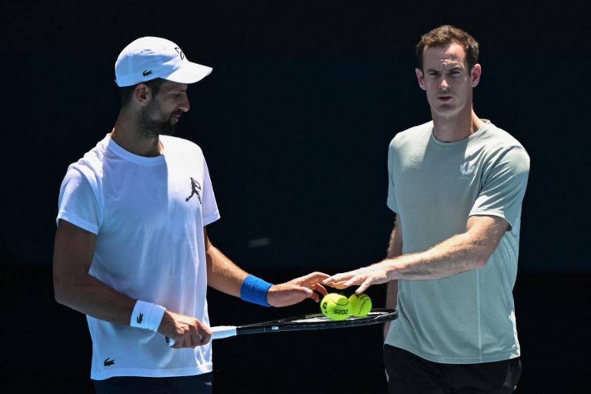 Serbia's Novak Djokovic (L) and his coach Andy Murray talk during a practice session ahead of the Australian Open tennis tournament in Melbourne on January 11, 2025. WILLIAM WEST / AFP