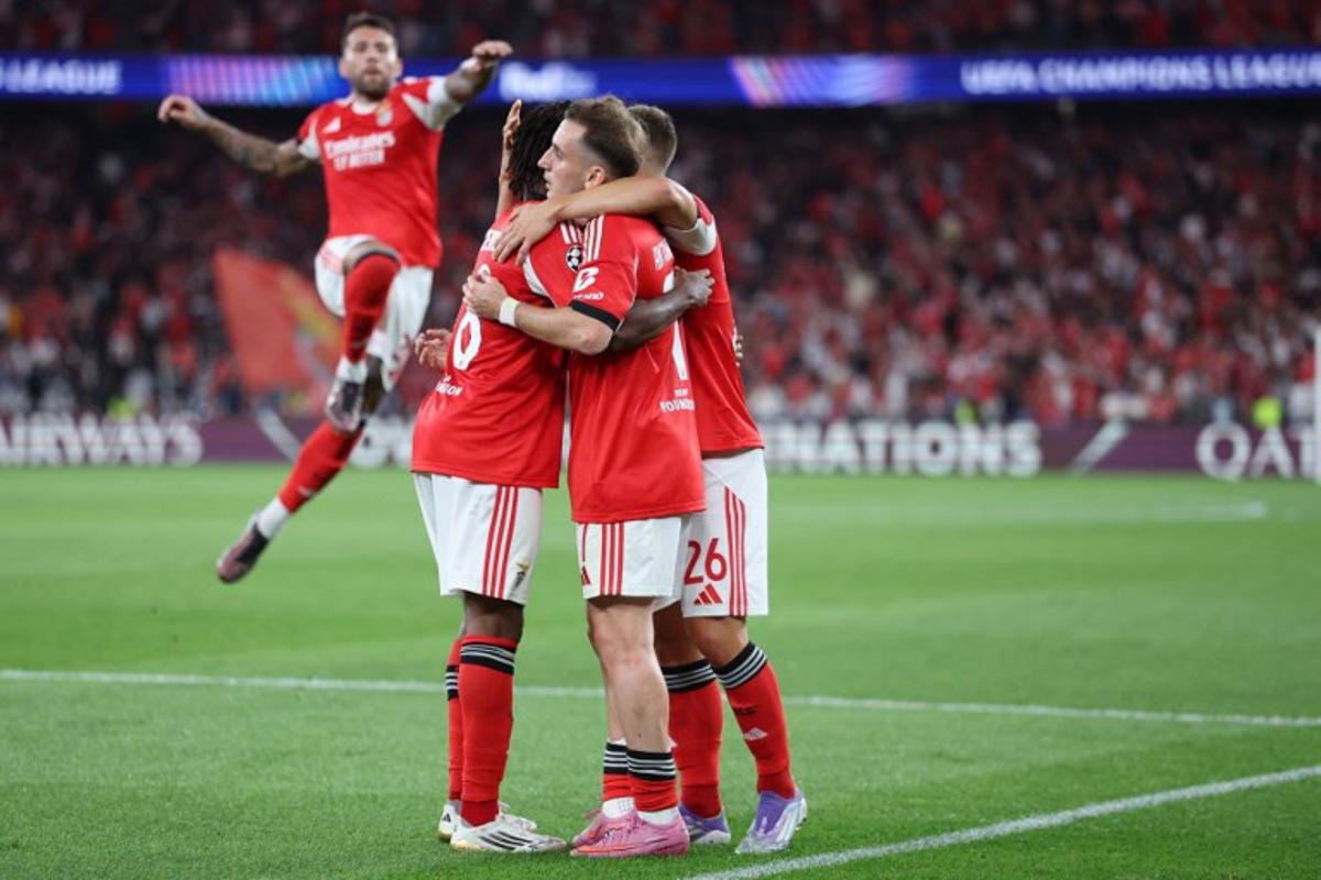 Benfica's Turkish forward #07 Muhammed Kerem Akturkoglu (2R) celebrates scoring the opening goal during the UEFA Champions League play off second leg football match between SL Benfica and Fenerbahce at Luz stadium in Lisbon on August 27, 2025. PATRICIA DE MELO MOREIRA / AFP