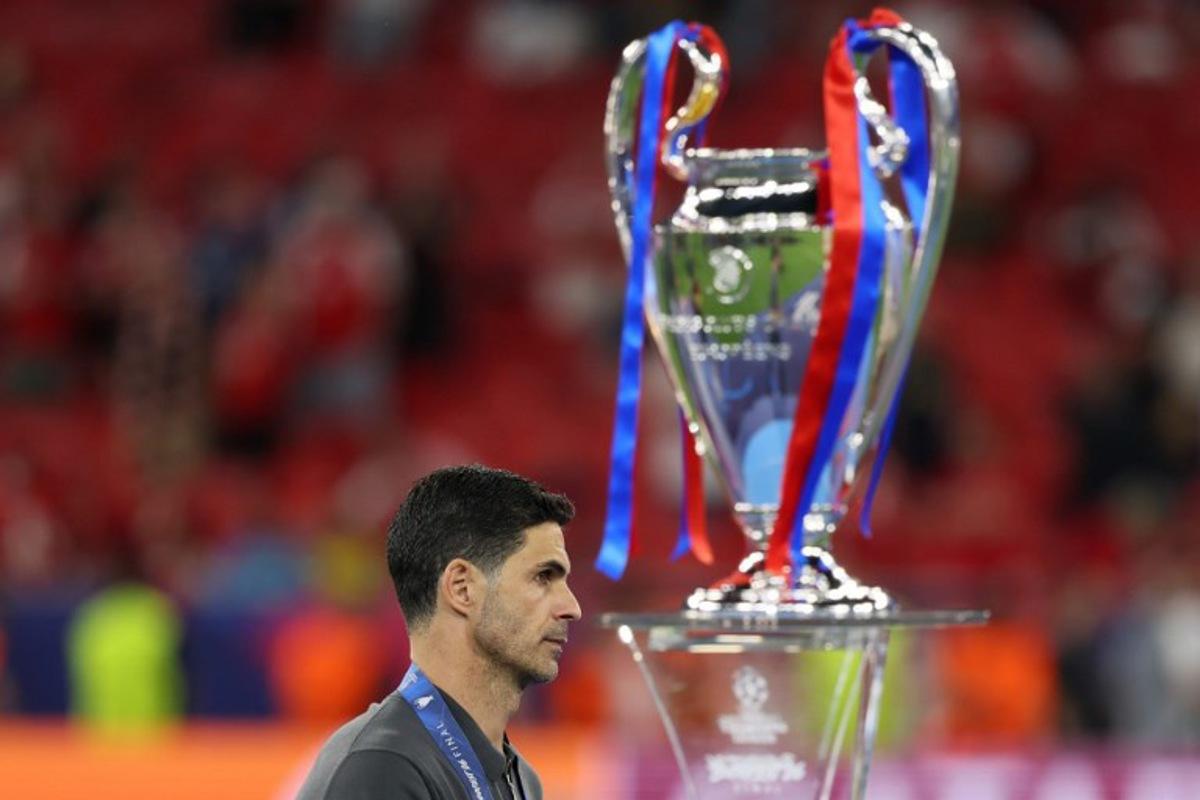 Arsenal's Spanish manager Mikel Arteta walks past the trophy following the UEFA Champions League final football match between Paris Saint-Germain (PSG) and Arsenal FC at the Puskas Arena in Budapest on May 30, 2026. Odd ANDERSEN / AFP