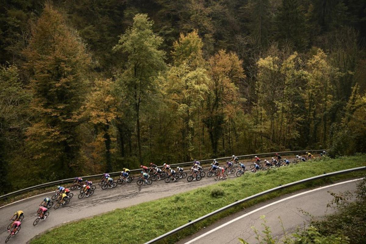 The pack of riders (peloton) cycles in the Passo Della Crocetta ascent during the 119th edition of the Giro di Lombardia (Tour of Lombardy), a 238km cycling race from Como to Bergamo on October 11, 2025. Marco BERTORELLO / AFP