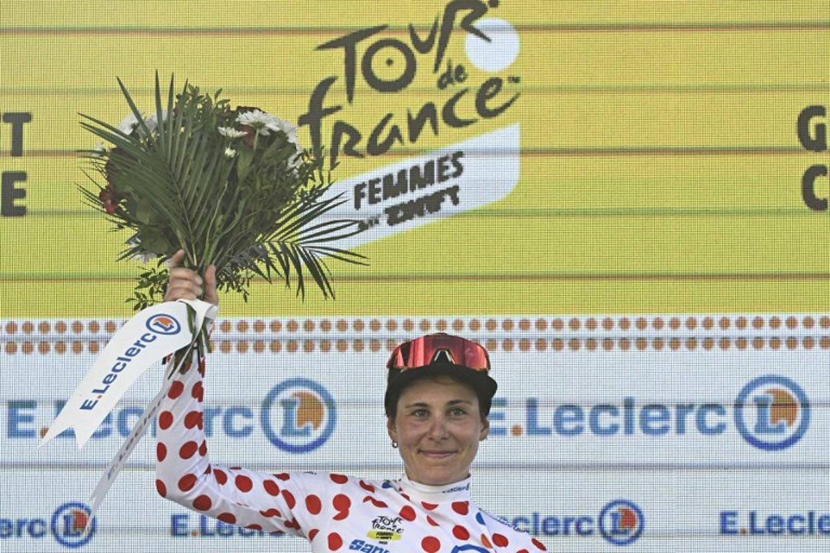 Guest and FDJ-SUEZ team's Swiss rider Elise Chabbey celebrates on the podium with the best climber's polka dot (dotted) jersey after the 5th stage (out of 9) of the fourth edition of the Women's Tour de France cycling race, 165.8 km from Chasseneuil-du-Poitou to Gueret, in Gueret, central France on July 30, 2025. JULIEN DE ROSA / AFP
