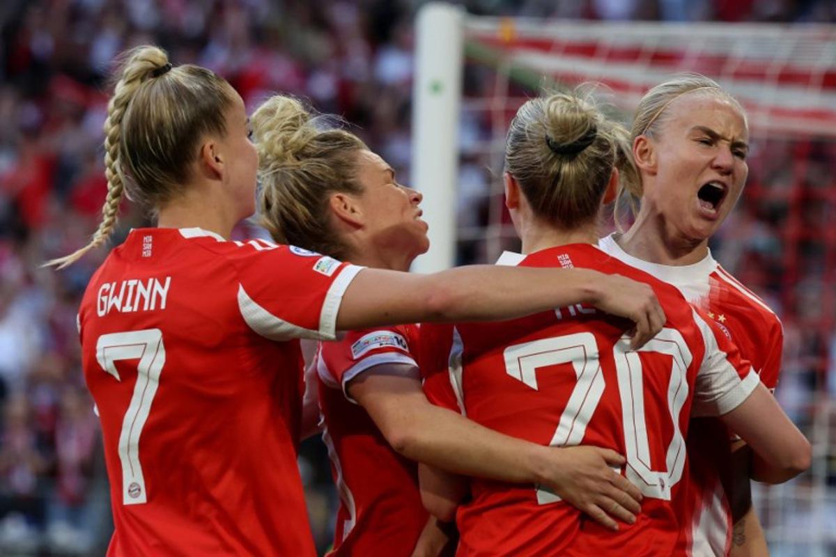 Bayern Munich's German forward #20 Franziska Kett (2nd R) celebrates scoring the 1-1 goal with her teammates during the UEFA Women's Champions League semi-final first leg football match between FC Bayern Munich and FC Barcelona in Munich, southern Germany on April 25, 2026. Karl-Josef HILDENBRAND / AFP