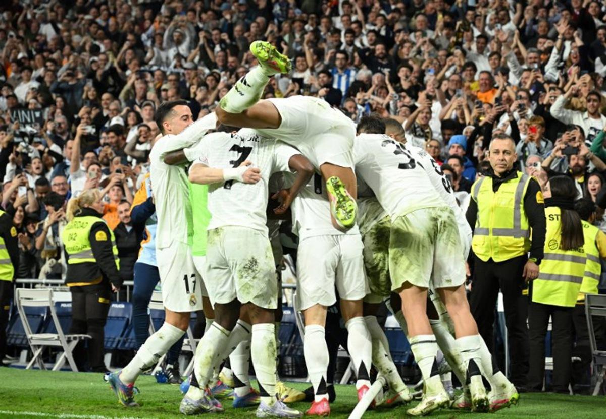 Real Madrid's players celebrate after French midfielder #14 Aurelien Tchouameni scored his team's third goal during the Spanish Copa del Rey (King's Cup) semi-final second leg football match between Real Madrid CF and Real Sociedad at the Santiago Bernabeu stadium in Madrid on April 1, 2025. JAVIER SORIANO / AFP