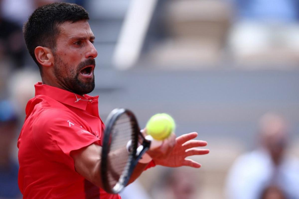 Serbia's Novak Djokovic plays a forehand return to Britain's Cameron Norrie during their men's singles match on day 9 of the French Open tennis tournament on Court Philippe-Chatrier at the Roland-Garros Complex in Paris on June 2, 2025. Anne-Christine POUJOULAT / AFP