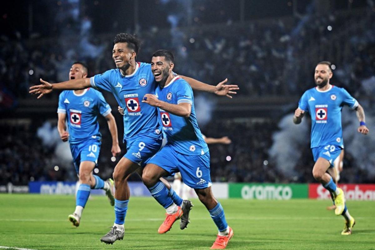 Cruz Azul's forward #09 Angel Sepulveda (L) celebrates with teammate midfielder #06 Erik Lira after scoring a penalty kick and his team's first goal during the CONCACAF Champions Cup all-Mexican semi-final second leg match between Cruz Azul and Tigres at the Olimpico Universitario stadium in Mexico City on May 1, 2025. Carl de Souza / AFP