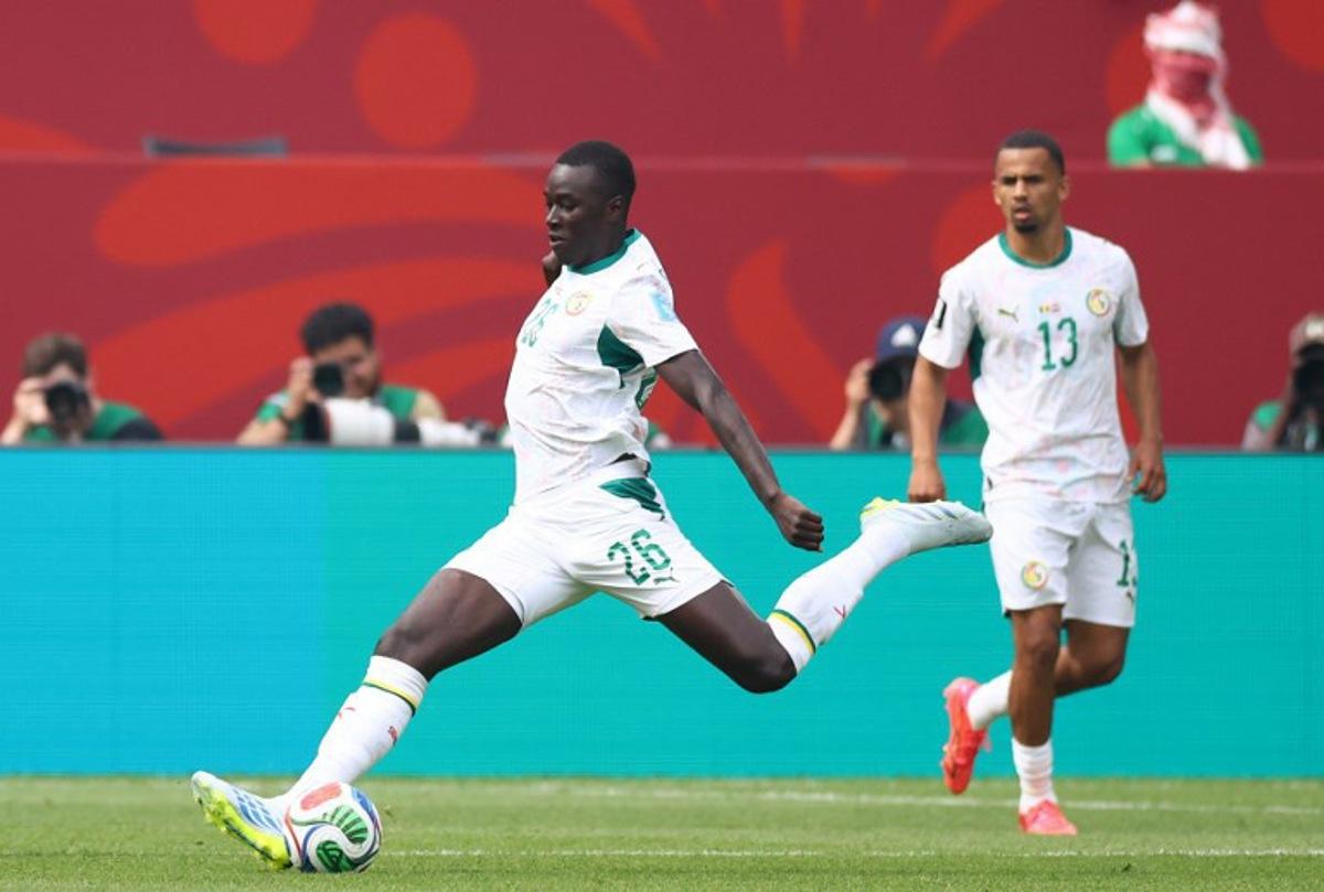 Senegal's midfielder #26 Pape Gueye scores his team's third goal during the 2026 World Cup Group I football match between Senegal and Iraq at the Toronto Stadium in Toronto on June 26, 2026. Cole Burston / AFP