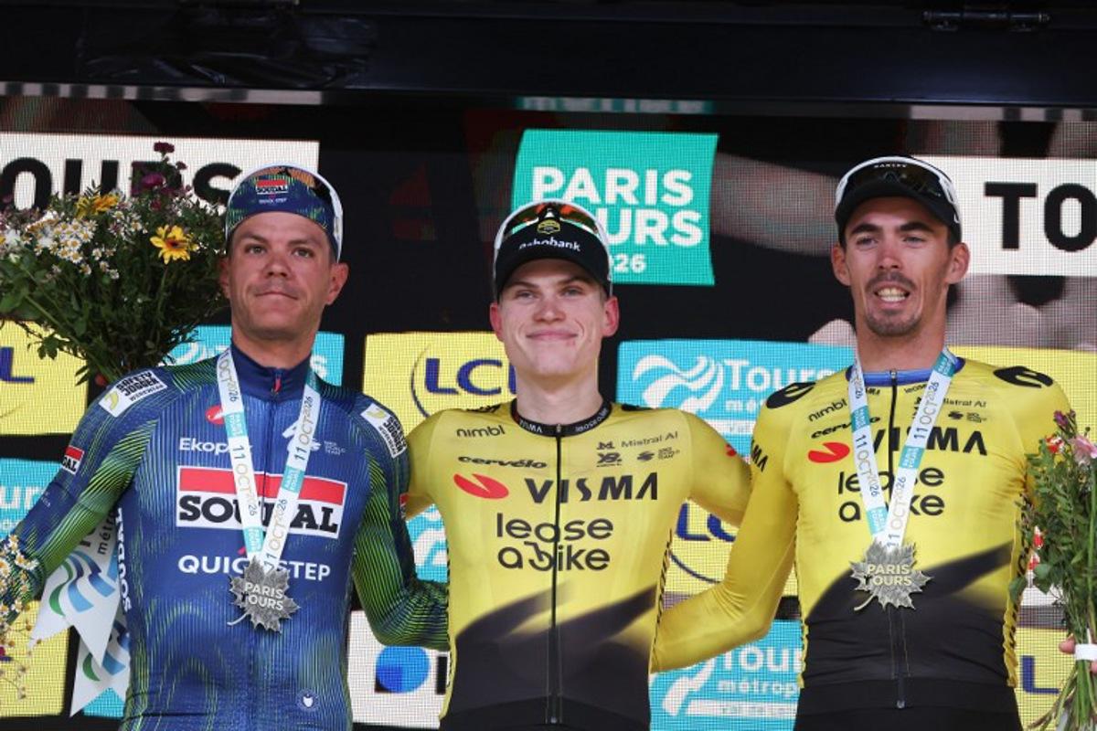 Team Visma Lease a Bike's Norwegian rider Per Strand Gagenes (C) celebrates on the podium flanked by second-placed Soudal Quick-Step's Belgian rider Jasper Stuyven (L) and third-placed Team Visma Lease a Bike's Christophe Laporte (R), after winning the 120th edition of Paris-Tours, a 216-km cycling race from Chartres to Tours, in Tours, France, on October 11, 2026. Alain JOCARD / AFP