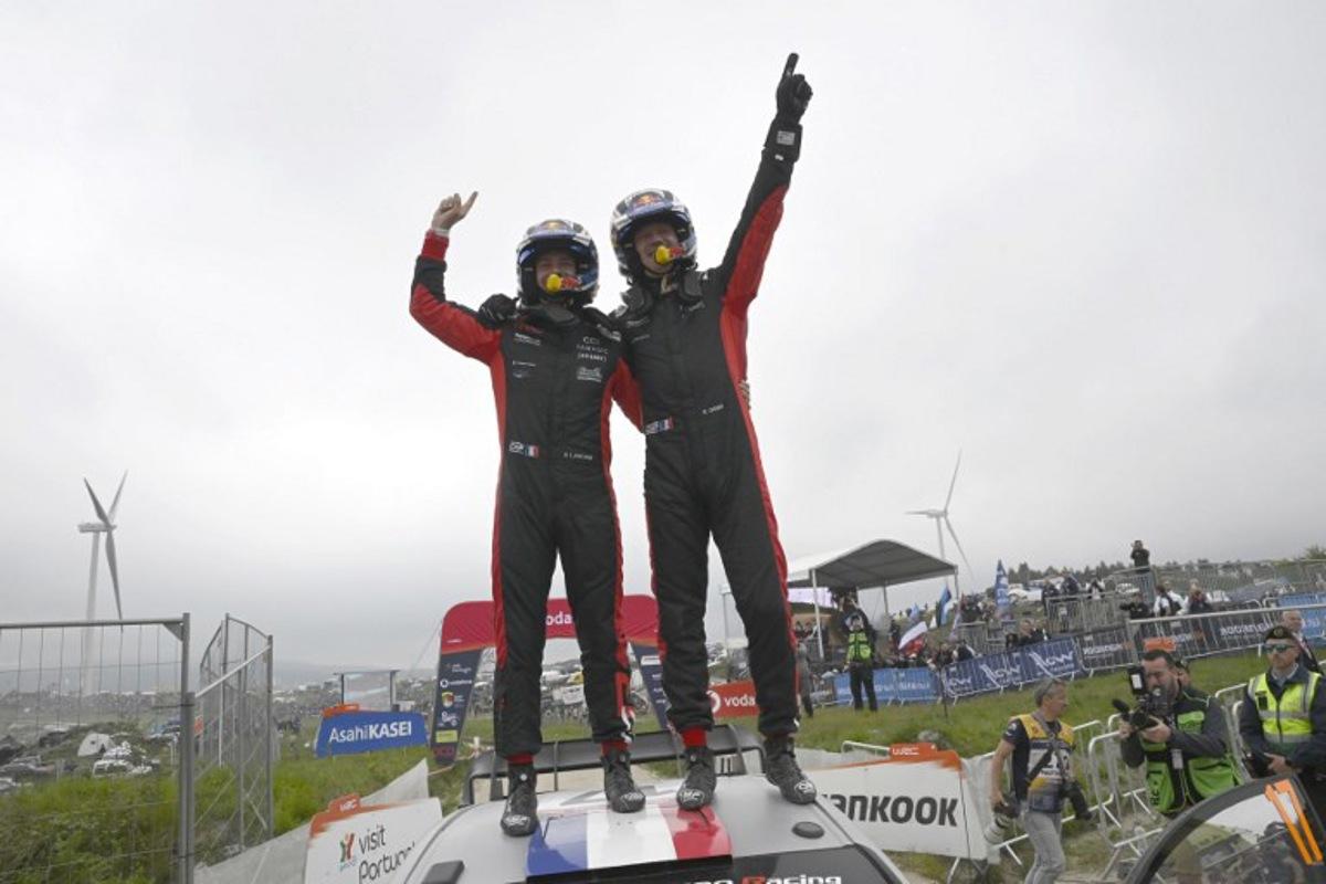 French driver Sebastien Ogier (R) and co-driver Vincent Landais celebrate on top of their Toyota GR Yaris Rally 1 after winning the World Rally Championship (WRC) Rally of Portugal at the end of the SS24 stage in Fafe, on May 18, 2025. MIGUEL RIOPA / AFP