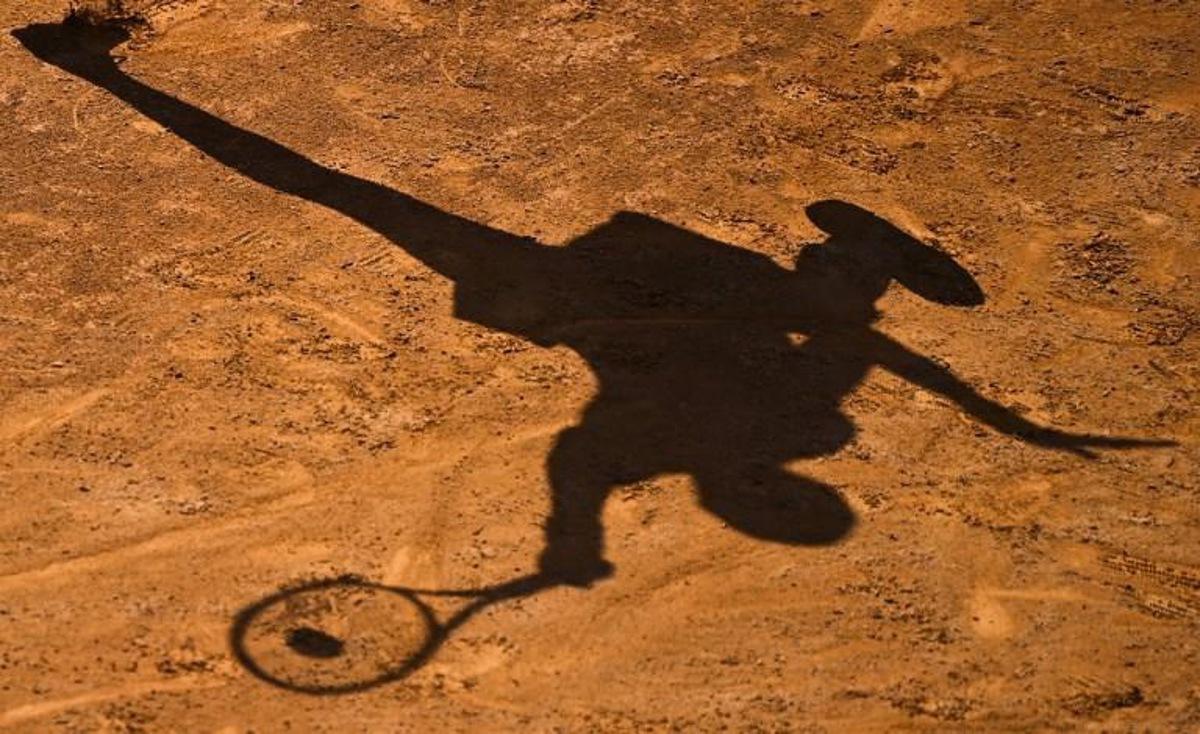 The shadow of USA's Cori Gauff is cast on the clay as she plays a forehand to Spain's Garbine Muguruza on day four of the Women's Italian Open at Foro Italico on September 17, 2020 in Rome, Italy. Riccardo Antimiani / POOL / AFP