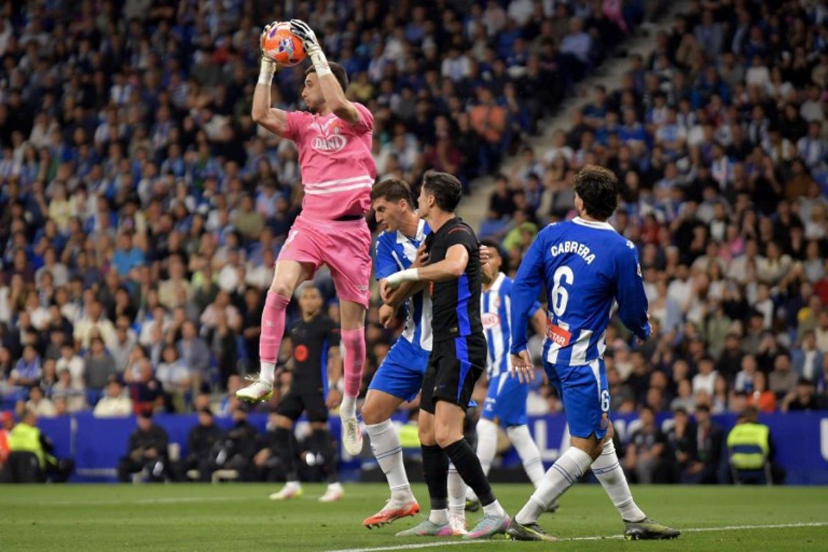 Espanyol's Spanish goalkeeper #01 Joan Garcia catches the ball during the Spanish league football match between RCD Espanyol and FC Barcelona at the RCDE Stadium in Cornella de Llobregat, on May 15, 2025. MANAURE QUINTERO / AFP