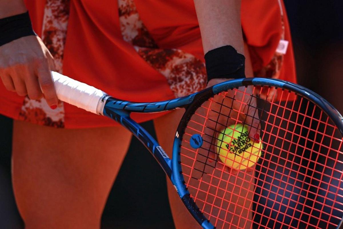 Russia's Elina Avanesyan holds a ball as she plays against Switzerland's Belinda Bencic during their women's singles match on day two of the Roland-Garros Open tennis tournament at the Court Suzanne-Lenglen in Paris on May 29, 2023. Anne-Christine POUJOULAT / AFP