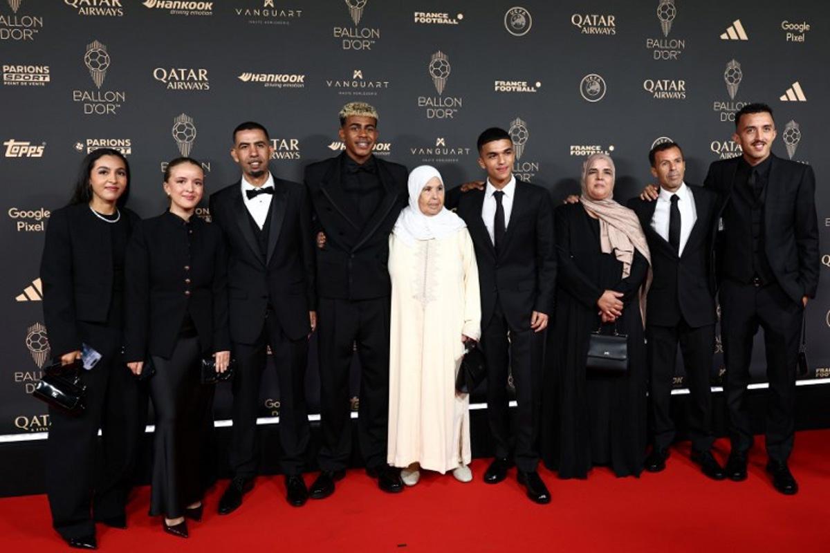 Barcelona's Spanish forward Lamine Yamal (4thL) poses with his family upon arrival before the 2025 Ballon d'Or France Football award ceremony at the Theatre du Chatelet in Paris on September 22, 2025. FRANCK FIFE / AFP