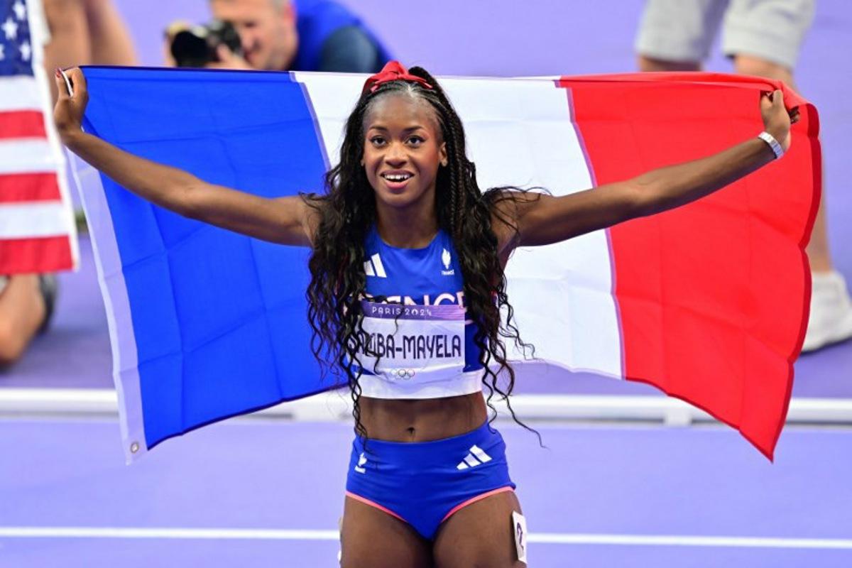 Silver medallist France's Cyrena Samba-Mayela celebrates after the women's 100m hurdles final of the athletics event at the Paris 2024 Olympic Games at Stade de France in Saint-Denis, north of Paris, on August 10, 2024. Martin BERNETTI / AFP