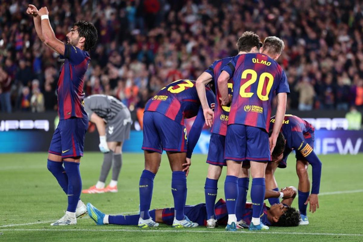 Barcelona's Spanish forward #07 Ferran Torres (L) asks for substitution as Barcelona's Spanish forward #10 Lamine Yamal lies on the ground after sustaining an injury during the Spanish league football match between FC Barcelona and RC Celta de Vigo at Camp Nou stadium in Barcelona on April 22 , 2026. Josep LAGO / AFP