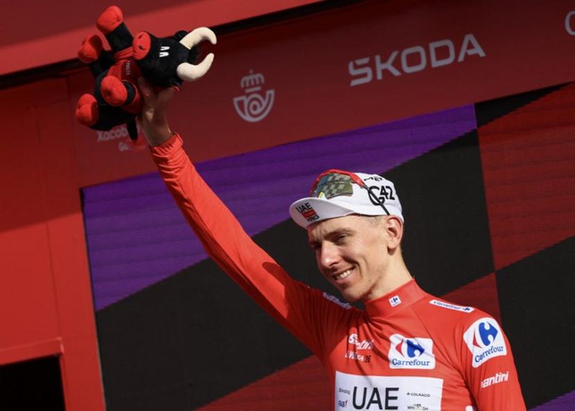 Overall race leader UAE Team Emirates - XRG team's Slovenian rider Tadej Pogacar celebrates on the podium the fifth stage of the Vuelta a Espana 2026, a 173,4 km race between Falset and Roquetes on August 26, 2026. Josep LAGO / AFP