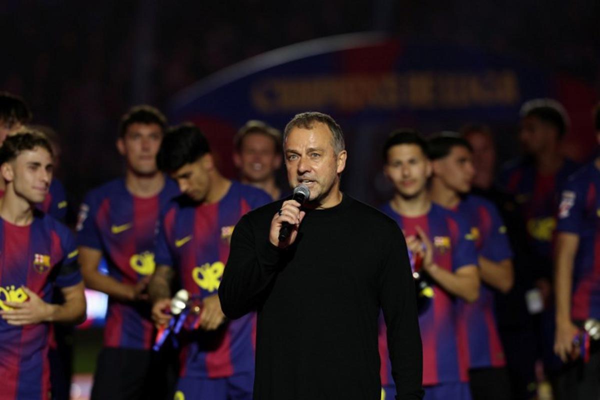 Barcelona's German coach Hans-Dieter Flick speaks as Barcelona's players celebrate winning the 2025-2026 Spanish League after the Spanish league football match between FC Barcelona and Real Madrid CF at Camp Nou Stadium in Barcelona on May 10, 2026. Lluis GENE / AFP