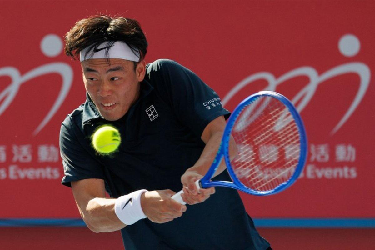 Hong Kong's Coleman Wong hits a return to Italy's Lorenzo Musetti during their men's singles quarter-final match at Hong Kong Tennis Open in Hong Kong on January 9, 2026. May JAMES / AFP
