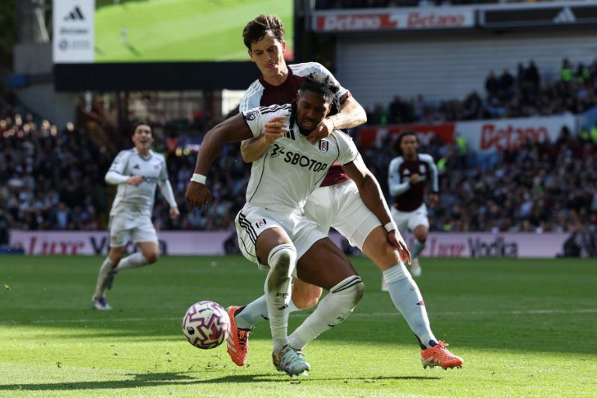 Aston Villa's Spanish defender #14 Pau Torres (R) vies with Fulham's Spanish midfielder #11 Adama Traore during the English Premier League football match between Aston Villa and Fulham at Villa Park in Birmingham, central England on September 28, 2025. Darren Staples / AFP