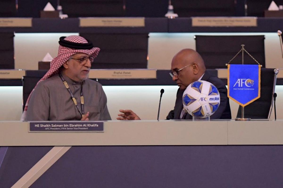 AFC President Salman bin Ibrahim al-Khalifa (L) speaks with AFC General Secretary Datuk Seri Windsor John during the 33rd Asian Football Confederation (AFC) Congress at the Gulf Convention Centre in Manama on February 1, 2023. Mazen Mahdi / AFP