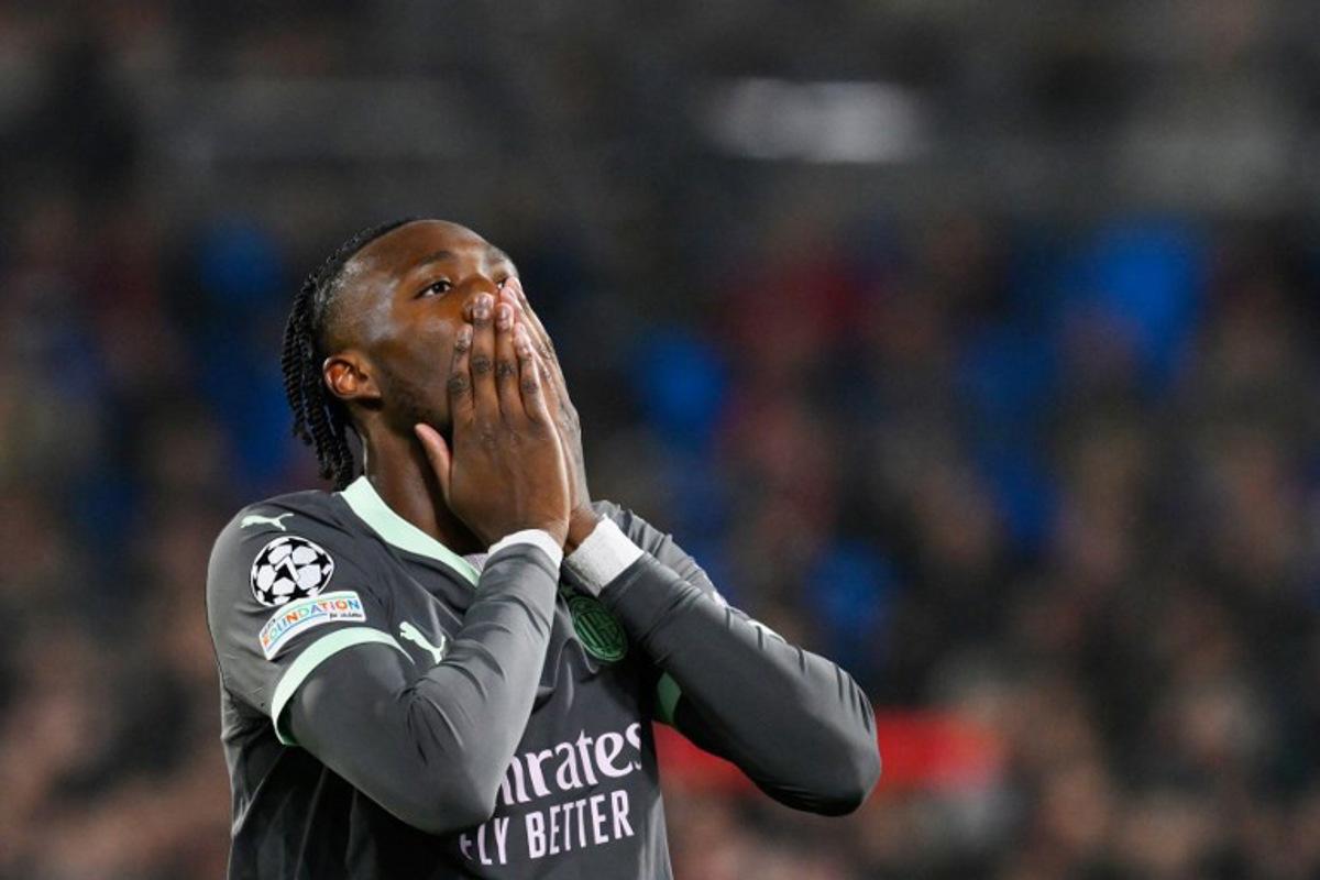 AC Milan's English forward #90 Tammy Abraham reacts during the UEFA Champions League knockout phase play-off 1st leg football match between Feyenoord Rotterdam and AC Milan at the Stadion Feijenoord "De Kuip" in Rotterdam, on February 12, 2025. JOHN THYS / AFP